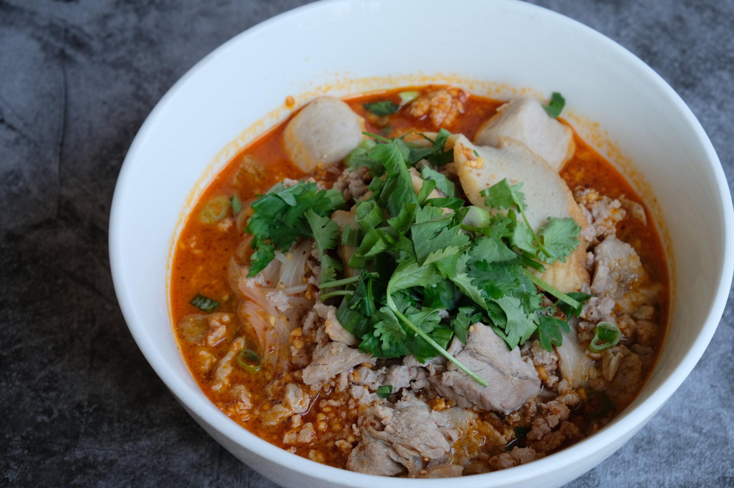 Tom Yum noodle soup — chili-lime broth with sliced pork, pork balls and fresh cilantro.